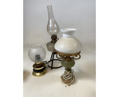 An oil lamp together with 2 electric lamps 