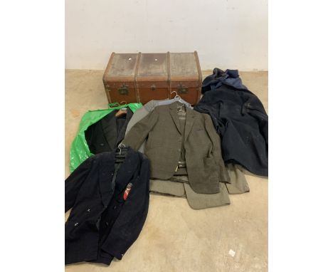A vintage wood bound suitcase and contents-suits and coats. 