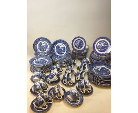 A large quantity of blue and white china comprising mainly willow pattern. Tea cups and saucers, tea plates, breakfast plates