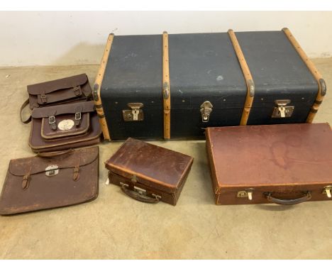 A wood bound travelling trunk also with vintage leather cases a and satchels.