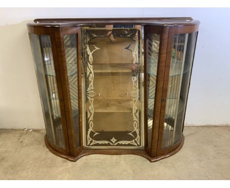 A Vintage early to mid 20th century glazed cabinet, curved doors to the sides with curved glass shelves, decorative central g