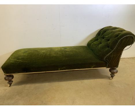 A Victorian button backed chaise lounge with bun feet and large ceramic castors. W:183cm x D:68cm x H:72cm