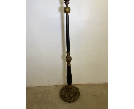 A black and gilt painted standard lamp with moulded decorative gilt base. H:155cm