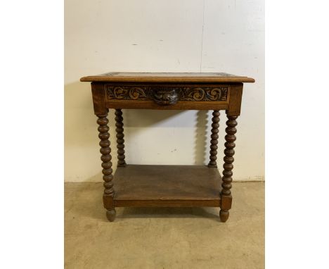A Victorian carved oak side table with bobbin turned legs and lion mask handle to drawer above lower shelf.W:69cm x D:43cm x 