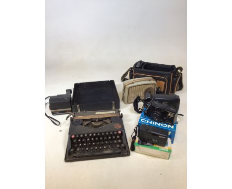 A portable vintage typewriter, a Dansette radio and a quantity of cameras