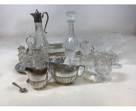 A glass tray with silver plated surround, a claret jug and decanter, glasses, a condiment set and other silver plated items 