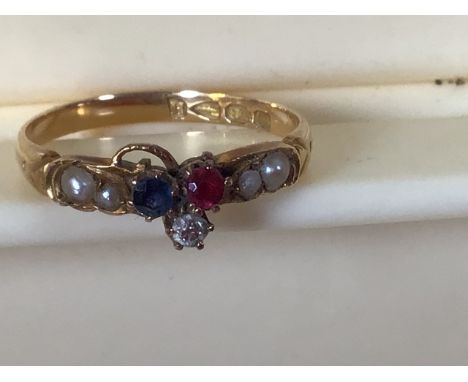 An 18 carat gold ring set with pearls,  a ruby, a diamond and a sapphire. Size 7.5 / O