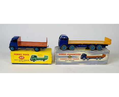 A Dinky Toys No. 433 guy flat truck (dark blue cab and chassis with blue hubs and orange back) comes in the original late iss