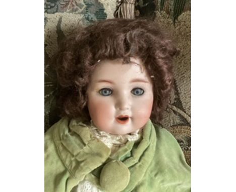 Antique S &amp; Quent Bisque head baby doll dressed in Green cloak .201 mold -some scrapes to head and has a small finger lac