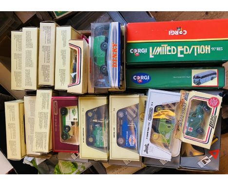 An assortment of boxed die cast vehicles, including commercials and buses. To include: Corgi, Matchbox, Solido. (qty)