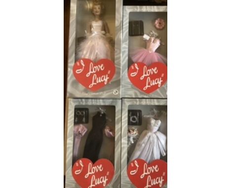 Franklin Mint; I Love Lucy Vinyl portrait dolls and 3 boxed Lucy outfits collection-all boxed and unused.(4)