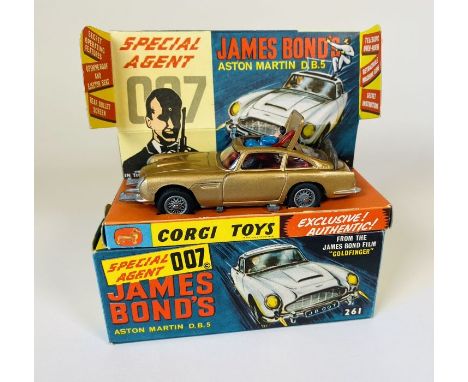 A Corgi Toys 261 James Bond (1965) Goldfinger Aston Martin DB5 diecast car. (gold body, wire wheels, silver trim and red inte