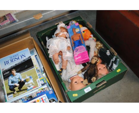 A box of various dolls to include Barbie Ken doll