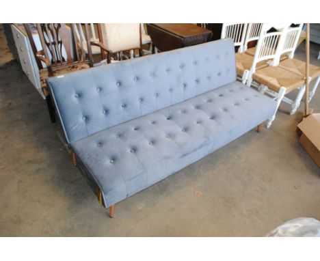 A grey upholstered sofa bed 