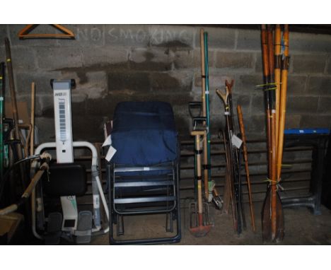A bundle of long handled gardening tools