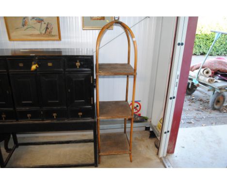 A cane three tier shelf