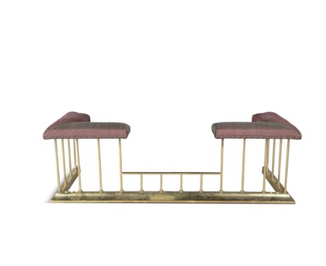 A BRASS CLUB FENDER, of compact proportions, with upholstered seat raised on turned columns and platform base. 152 x 58 x 47c