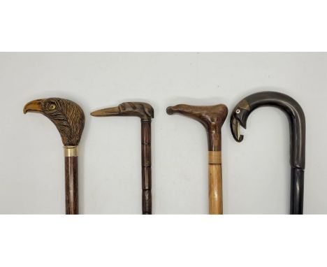 Four novelty handled walking sticks, to include: a tapering cane with carved horn handle fashioned as a greyhounds head, this