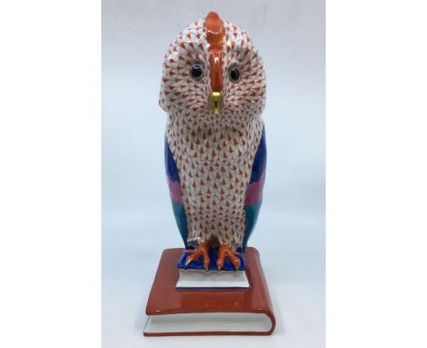 A large Herend porcelain model of an owl perched upon books, hand painted in colours and gold, printed blue mark, height 30cm