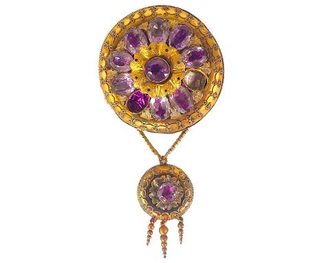 A Victorian high-purity gold (tests 15ct) foiled amethyst set drop circular brooch. With embossed and chased leaves surroundi
