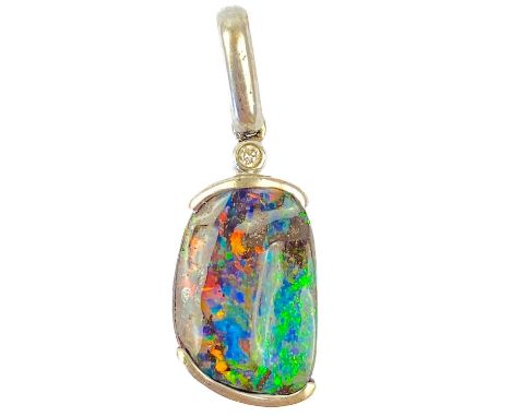 A contemporary 18ct white gold, black boulder opal and diamond set pendant. The irregular stone displaying orange, blue, gree