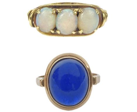 A 14ct white opal set three stone ring, and a cabochon blue spinel 14ct ring.  Stamped 585, size K, 3.3g; the synthetic spine