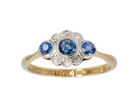 An 18ct gold and platinum collet set diamond and sapphire ring. Set with three round cut sapphires, the centre stone 0.15ct a