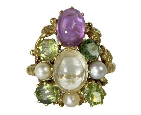 An Arts & Crafts high-purity gold gem set ring. Claw set with an oval cabochon white and pink sapphire, seed pearls, two oval