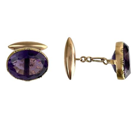 A pair of Edwardian gold oval cut amethyst set cufflinks. The amethyst in a rub over setting, each measuring 17.2 x 14mm, wit