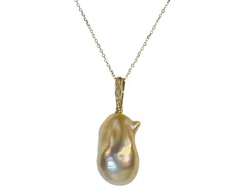 A contemporary 18ct pendant with a suspended large Baroque cultured pearl and with diamond set bale. The pearl measuring 22mm