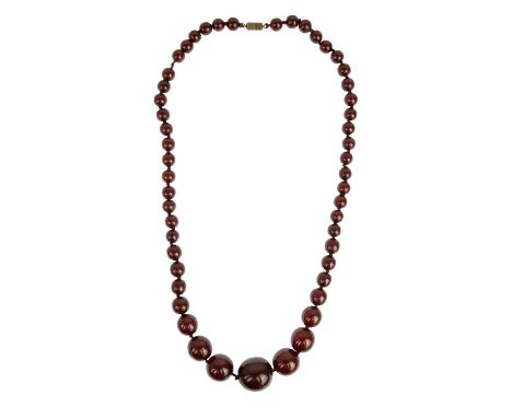 A cherry amber bakelite necklace. With round graduated beads, 56cm in length. 46.38g.Please see new photos online. Largest be