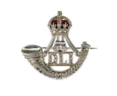 A 9ct white diamond set and red enamel WWII Durham Light Infantry sweetheart brooch. The DLI monogram and the crown band set 