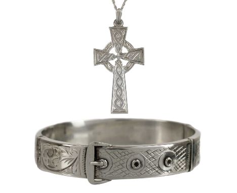 A silver bangle and cross pendant necklace. A silver buckle hinge bangle from Birmingham, 1962. A silver crucifix pendant fro