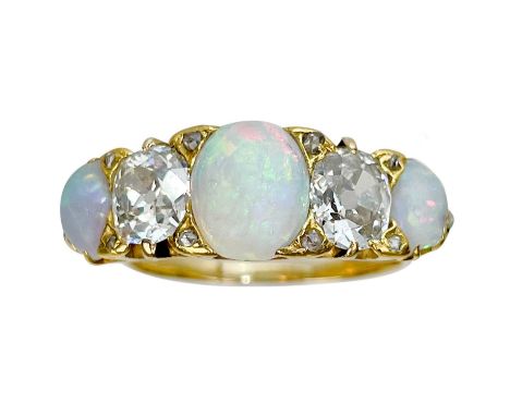 A good 18ct gold diamond and opal five stone ring. The two cushion cut diamonds each of 0.70ct approximately, the estimated c