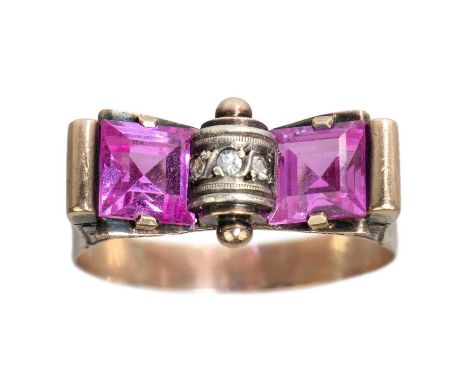 An Art Deco rose gold pink sapphire set 'tank' ring. Set with two square cut pink sapphires each 6.2 x 6.2mm, the centre set 