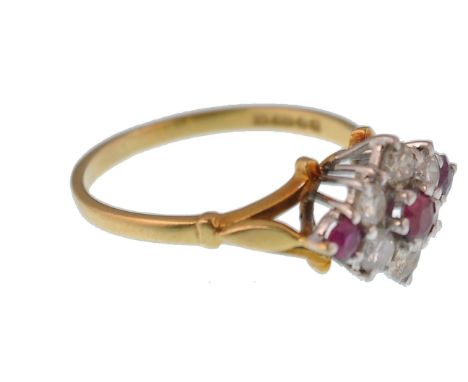 A hallmarked 18ct gold ruby and diamond cluster&nbsp; ring having a central ruby approx 10pnts being claw mounted and a clust