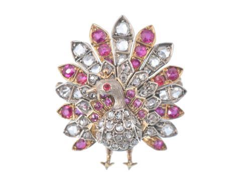 A gold diamond, ruby and red stone figural brooch.&nbsp; The brooch in the form of a peacock set with old and rose cut diamon