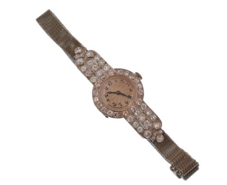 A 1920s Art Deco platinum, 18ct gold and diamond watch by Harrods of London. The platinum watch having an engine turned style