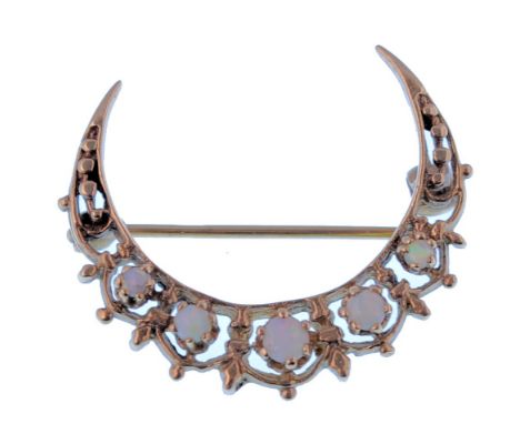 A 9ct gold and opal ladies London hallmarked crescent moon shaped brooch.5 graduating round cut opals being claw mounted with