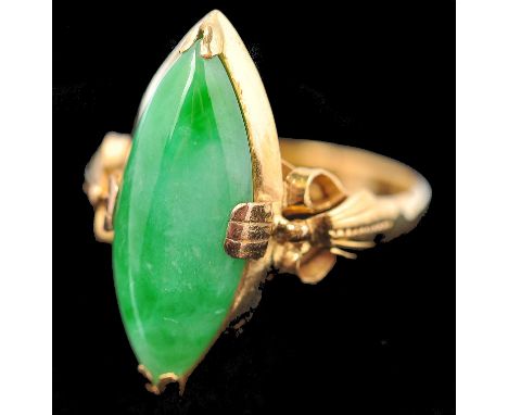 A 15ct gold and Jadeite ring. The ring having a large central Jade navette cabochon set to bow and swag style shoulders. Size