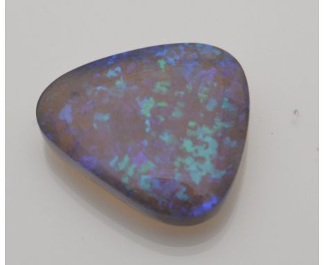 A single loose natural precious opal showing mainly blue and green play of colour. Weight 15.5cts. Measures approx 2cms x 2cm