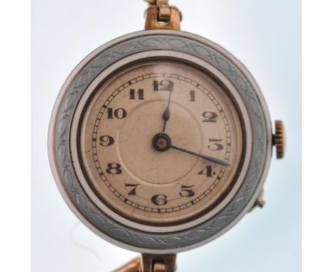 An early 20th century gold plated and enamel ladies bracelet watch. Enamel border with silvered dial on expanding strap.&nbsp