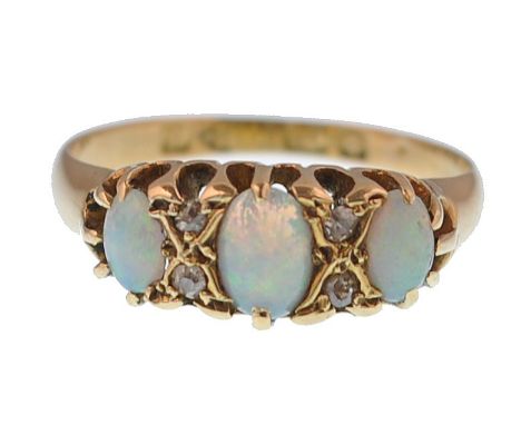 An Edwardian 9ct gold / 375 hallmarked opal and diamond 3 stone ring. The cabochon opals ( largest 5mm x 3.5mm) in a gypsy se