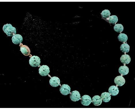 An early 20th century French carved turquoise colour bead necklace. The beads carved depicting Chinese symbolism,&nbsp; Shou 