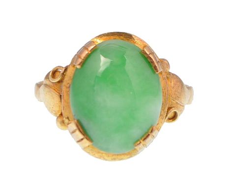 A 15ct gold and Jadeite ring. The ring having a large central Jade cabochon set to foliate style shoulders with certification