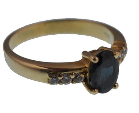 A 14ct gold / 585 marked ladies blue and white stone ring . The central claw set mixed cut stone,&nbsp; approx 6 x 4mm with t