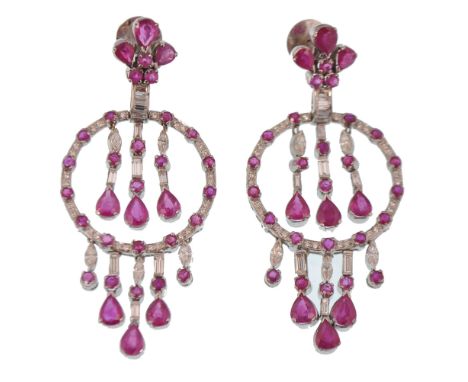 A pair of white 18ct gold French ruby and diamond oversized chandelier earrings. The earrings consisting of fleur de lys ruby