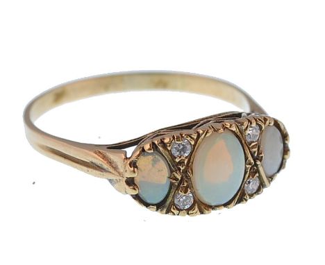 A 9ct gold / 375 hallmarked opal and diamond 3 stone ring. The cabochon opals ( largest 7mm x 5mm) in a gypsy setting having 