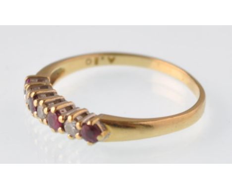 An 18ct gold ruby and diamond seven stone ring. Hallmarks for Birmingham 1993. Weight 2.0g