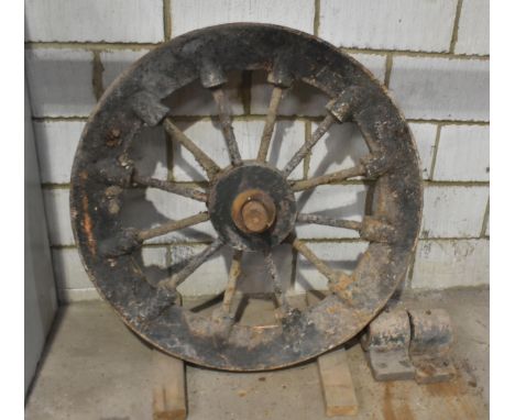 A heavy vintage spoked lift shaft wheel